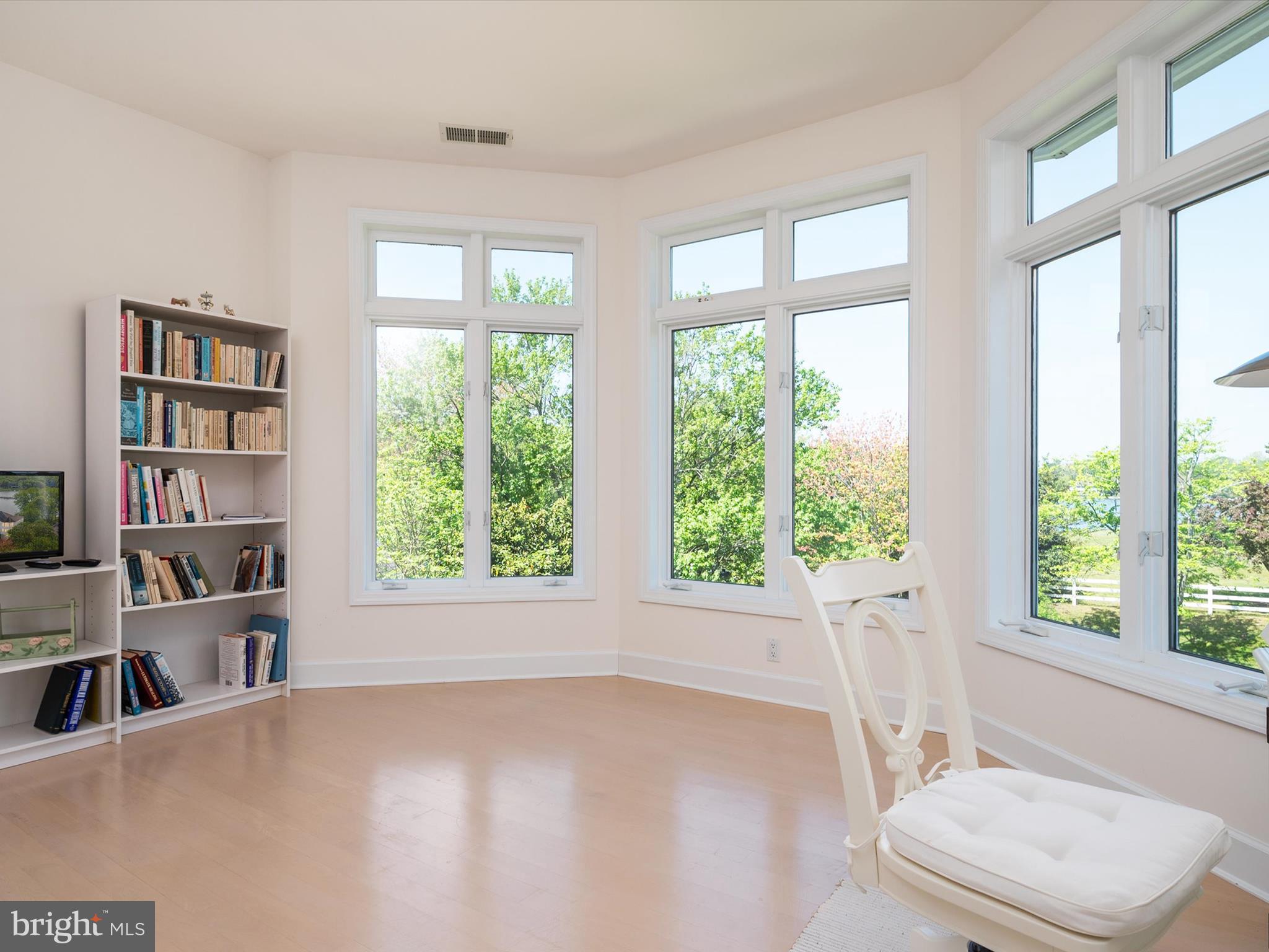 1237 Cherry Tree Lane Annapolis, MD 21403 - Photo 49 of 86 a view of a bedroom with a large window and a book shelf
