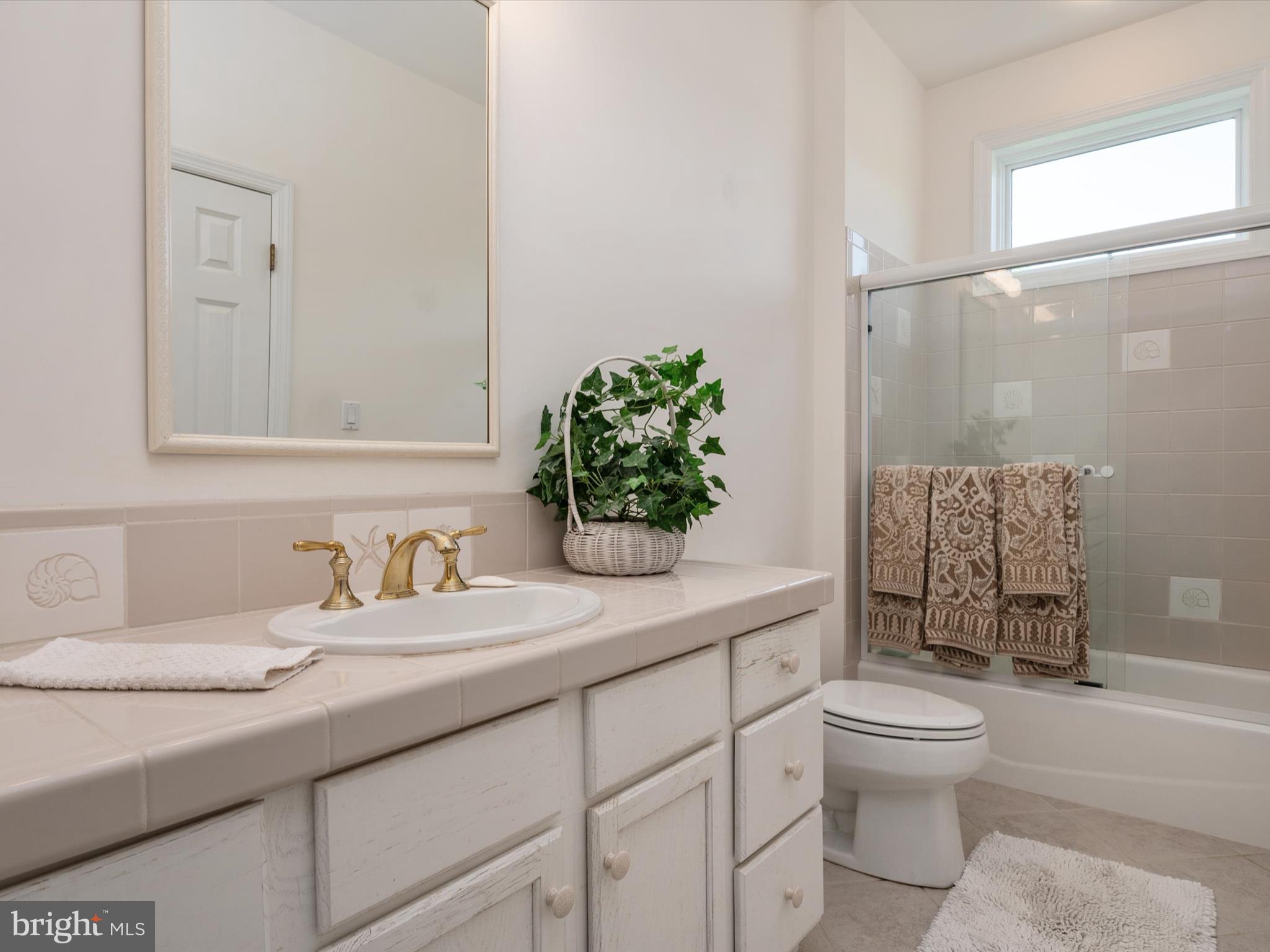 1237 Cherry Tree Lane Annapolis, MD 21403 - Photo 50 of 86 a bathroom with a granite countertop sink a toilet and shower