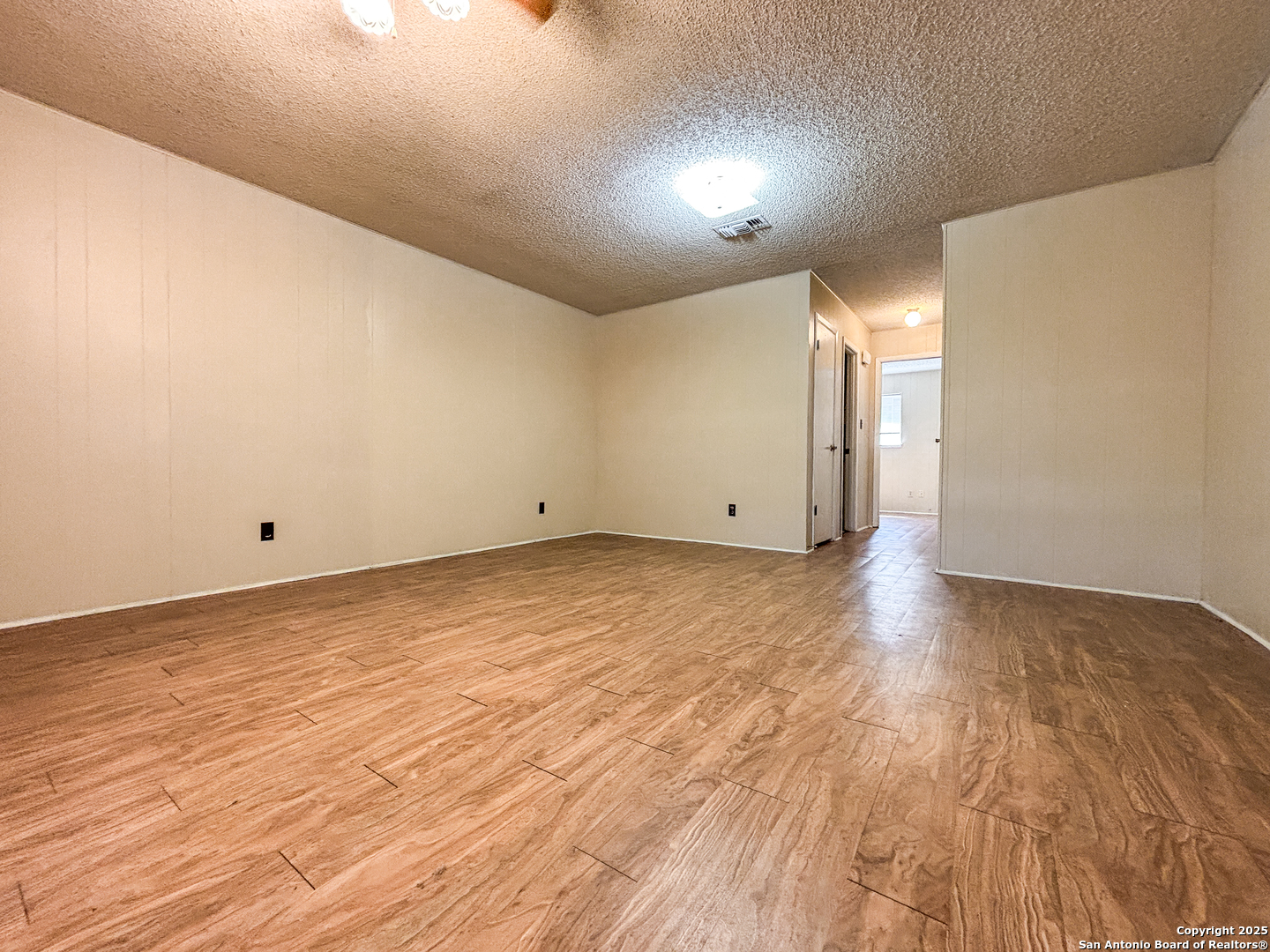 207 Redbud Lane, Unit B New Braunfels, TX 78130 - Photo 3 of 11 a view of empty room with wooden floor