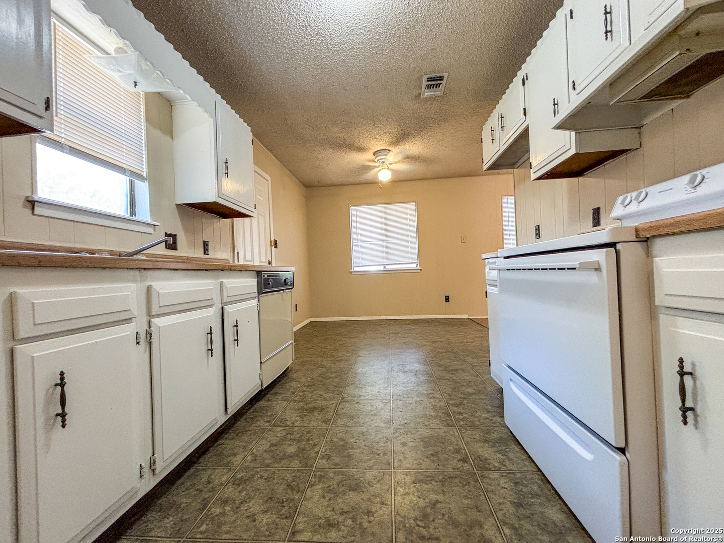 207 Redbud Lane, Unit B New Braunfels, TX 78130 - Photo 6 of 11 a kitchen with a sink refrigerator and window