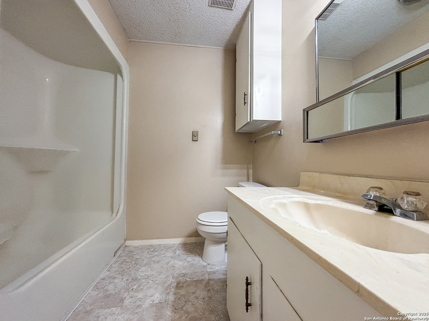 207 Redbud Lane, Unit B New Braunfels, TX 78130 - Photo 9 of 11 a bathroom with a sink a toilet and shower
