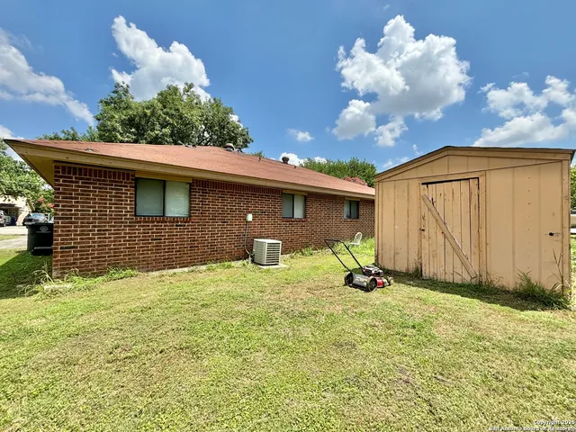 a view of backyard with a garden and entertaining space
