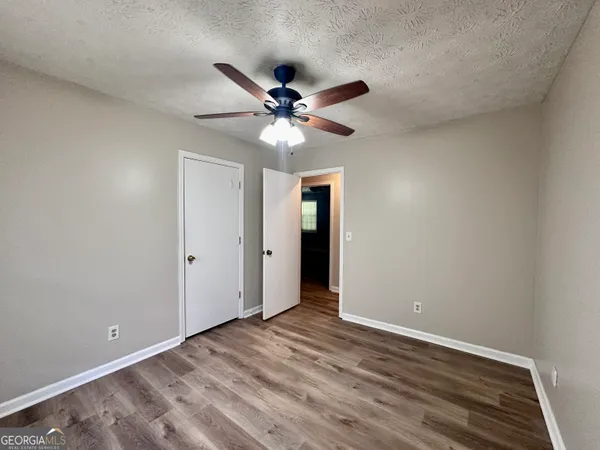a view of an empty room with a fan