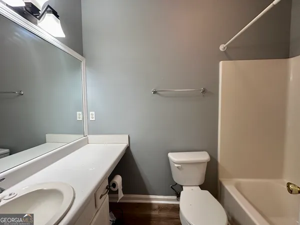 a bathroom with a toilet a sink and bathtub