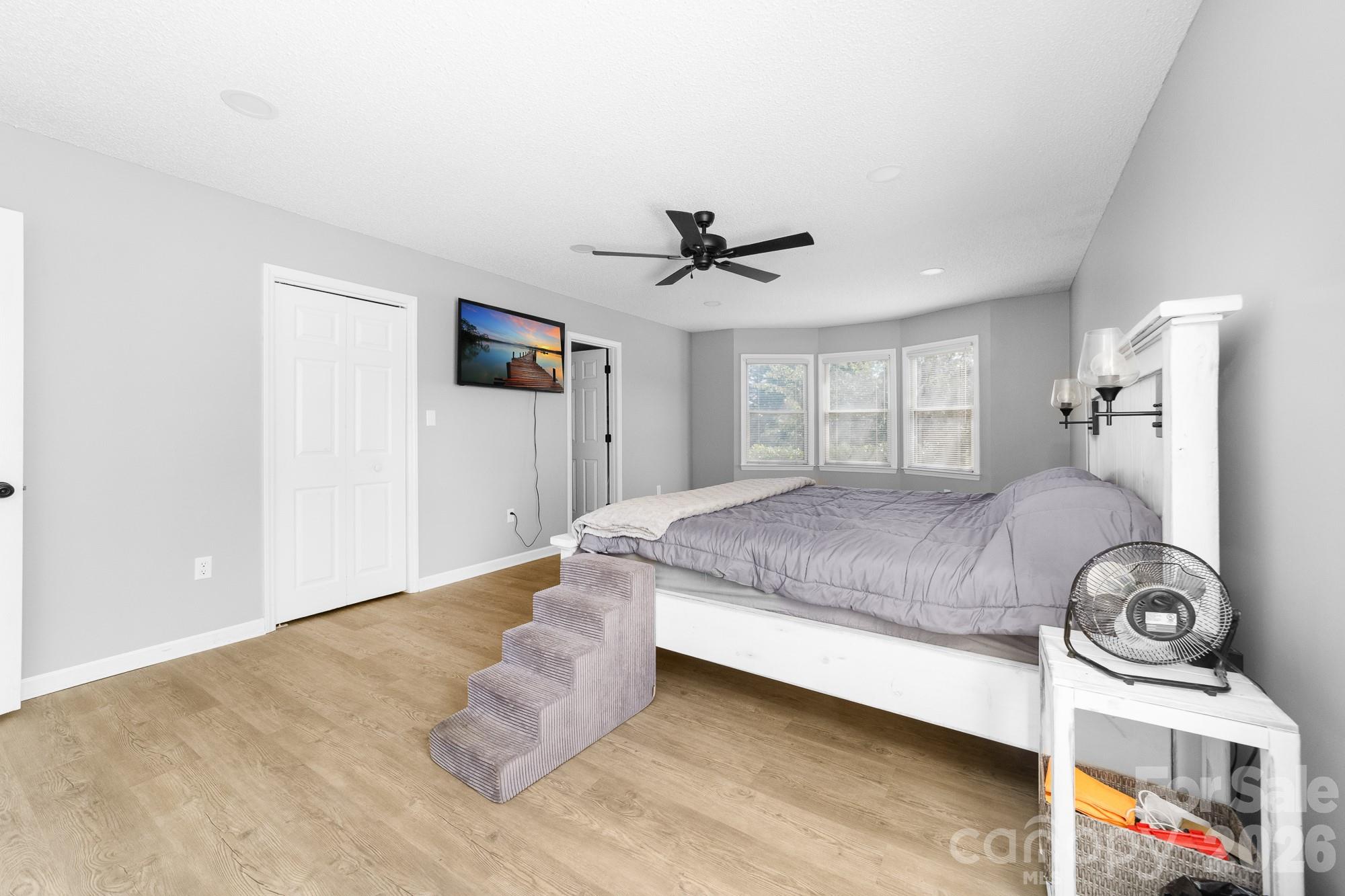 248 Jack McKinney Road Forest City, NC 28043 - Photo 13 of 29 a bedroom with a bed and a ceiling fan