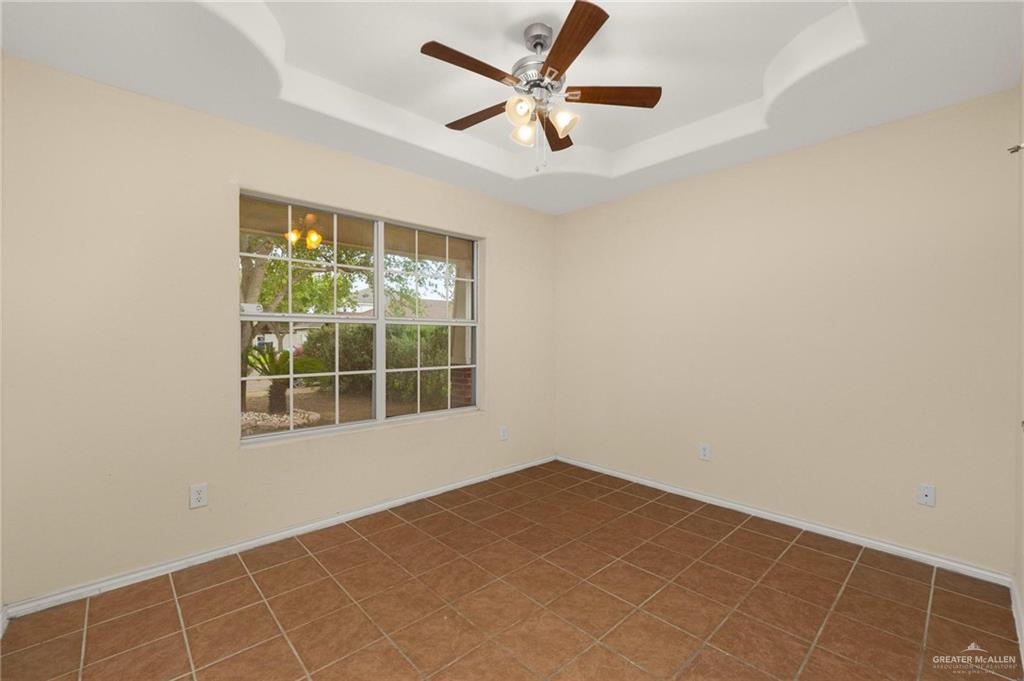 4716 Xanthisma Avenue McAllen, TX 78504 - Photo 13 of 17 an empty room with a window and a fan