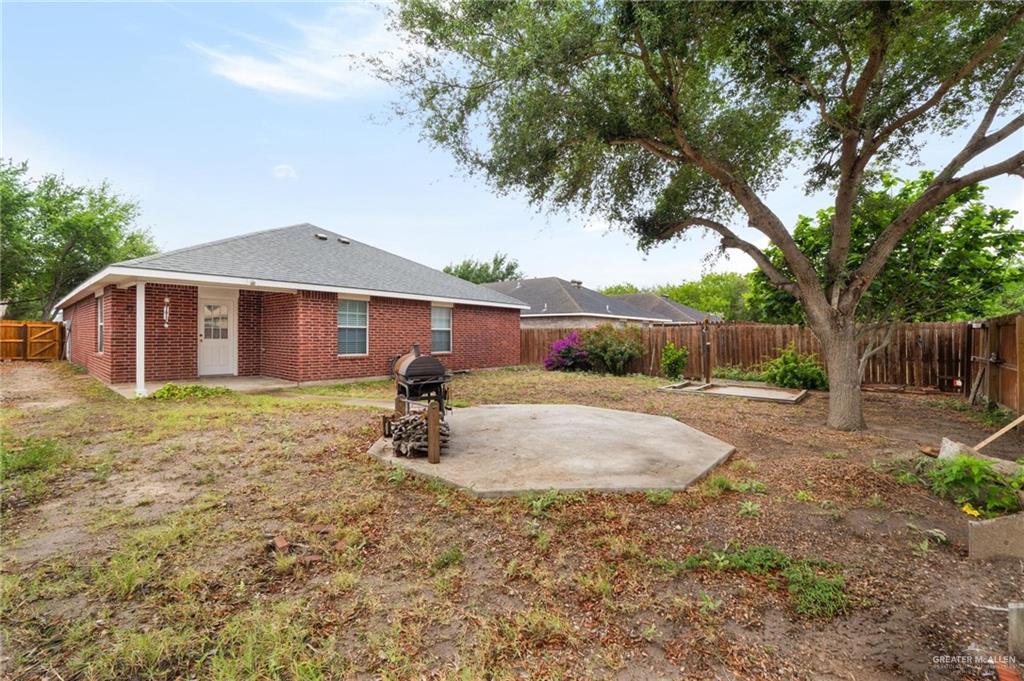 4716 Xanthisma Avenue McAllen, TX 78504 - Photo 14 of 17 a backyard of a house with table and chairs under an umbrella