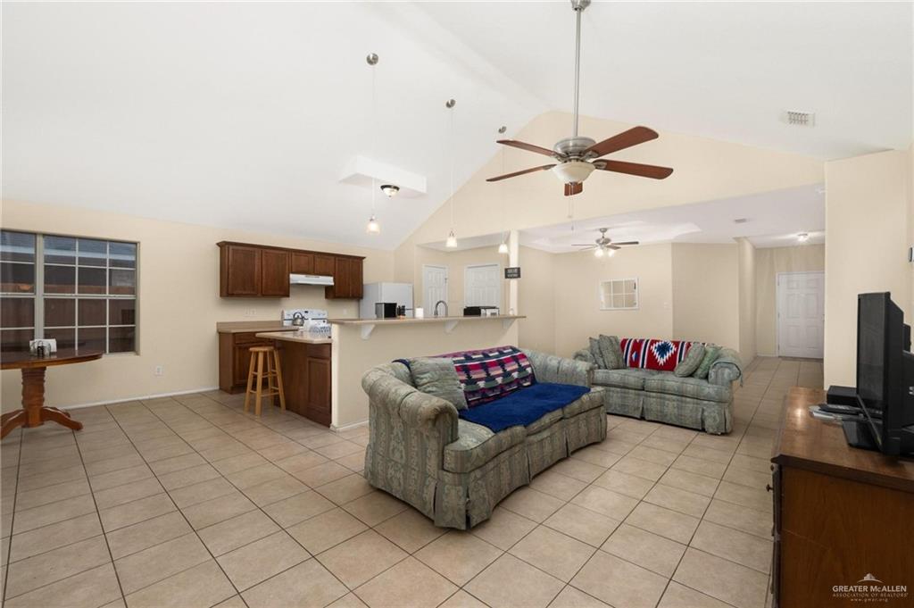 4716 Xanthisma Avenue McAllen, TX 78504 - Photo 2 of 17 a living room with furniture a flat screen tv and kitchen view