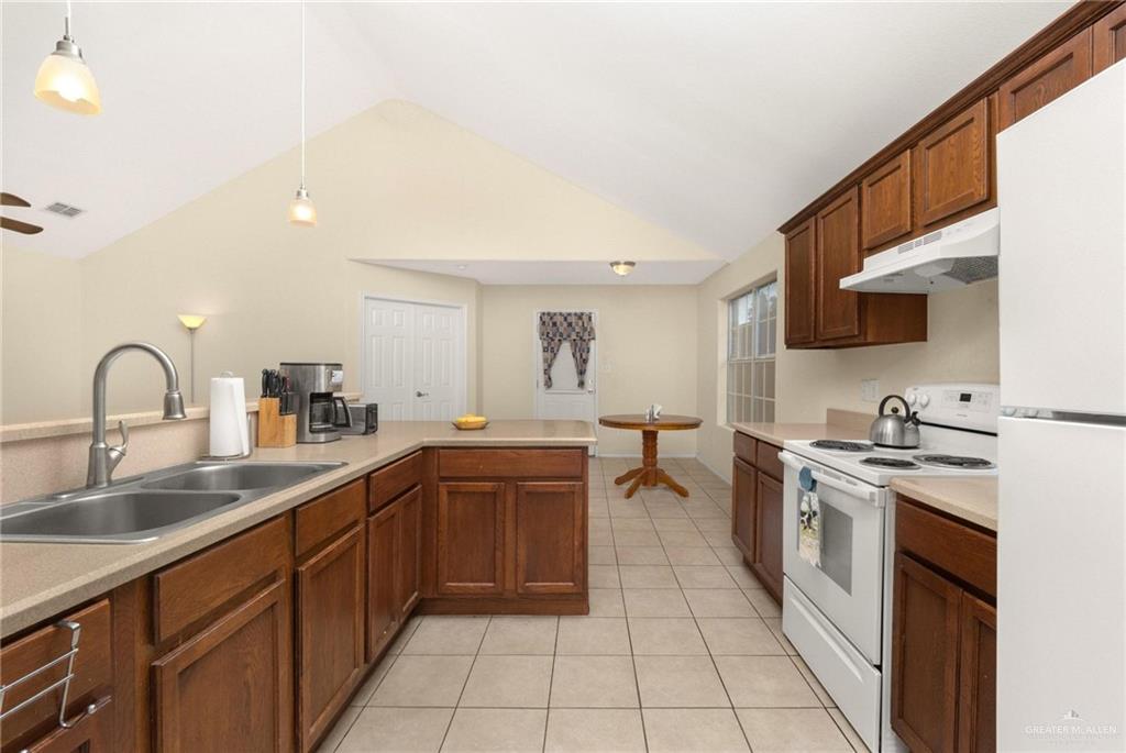 4716 Xanthisma Avenue McAllen, TX 78504 - Photo 4 of 17 a kitchen with a sink white cabinets and stainless steel appliances