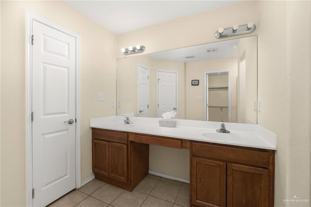 4716 Xanthisma Avenue McAllen, TX 78504 - Photo 8 of 17 a bathroom with a double vanity sink and mirror