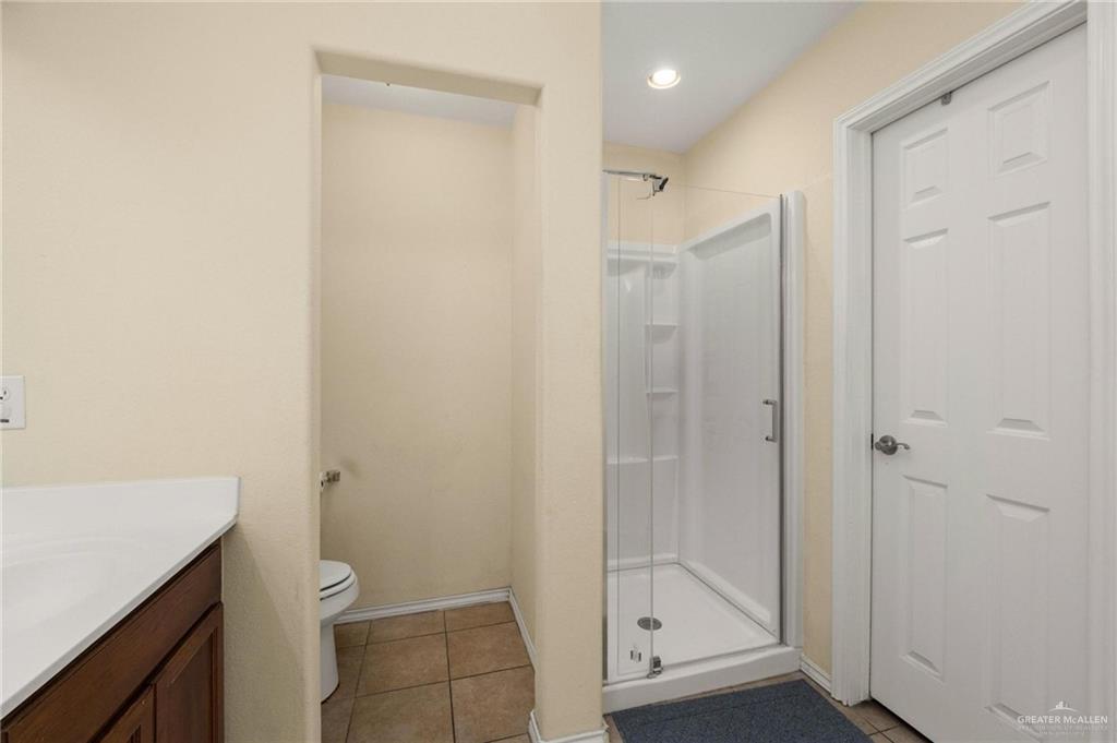 4716 Xanthisma Avenue McAllen, TX 78504 - Photo 9 of 17 a bathroom with a shower a toilet and a sink