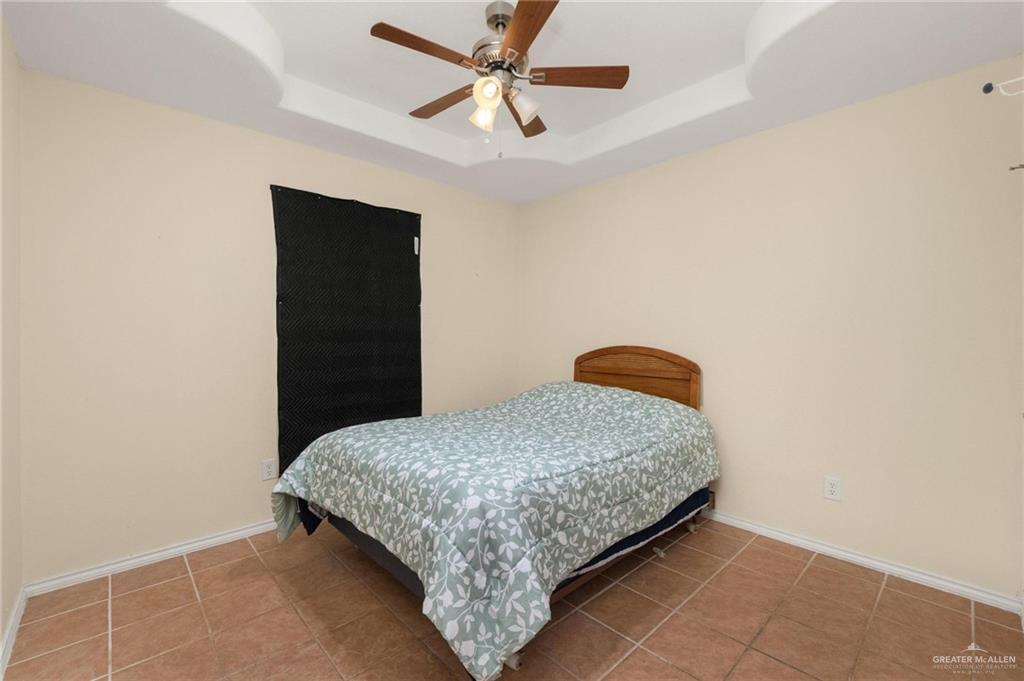 4716 Xanthisma Avenue McAllen, TX 78504 - Photo 10 of 17 a bedroom with a bed and a cabinets