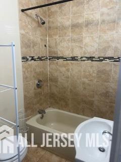 331 Watson Avenue, Unit 1 Perth Amboy, NJ 08861 - Photo 2 of 4 a bathroom with a sink and a shower