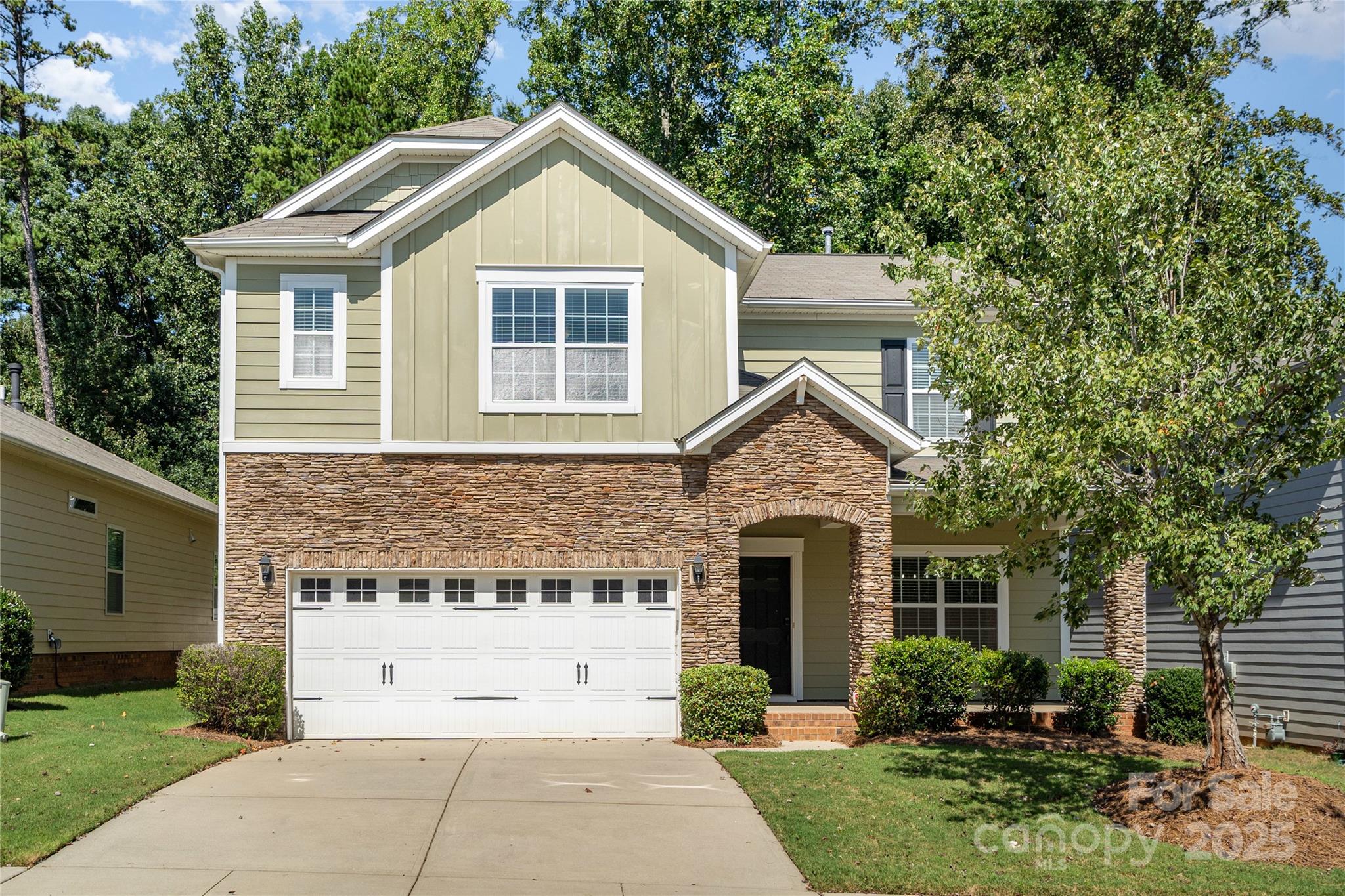 1528 Spring Blossom Trail Fort Mill, SC 29708 - Photo 1 of 26 a front view of a house with a garden