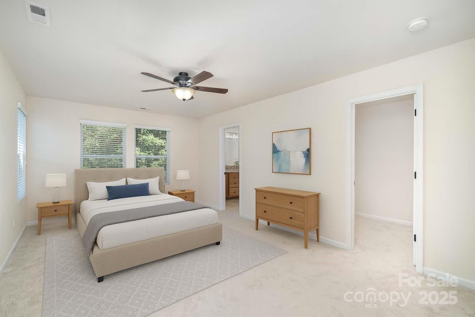 1528 Spring Blossom Trail Fort Mill, SC 29708 - Photo 13 of 26 a bedroom with a bed and a chandelier