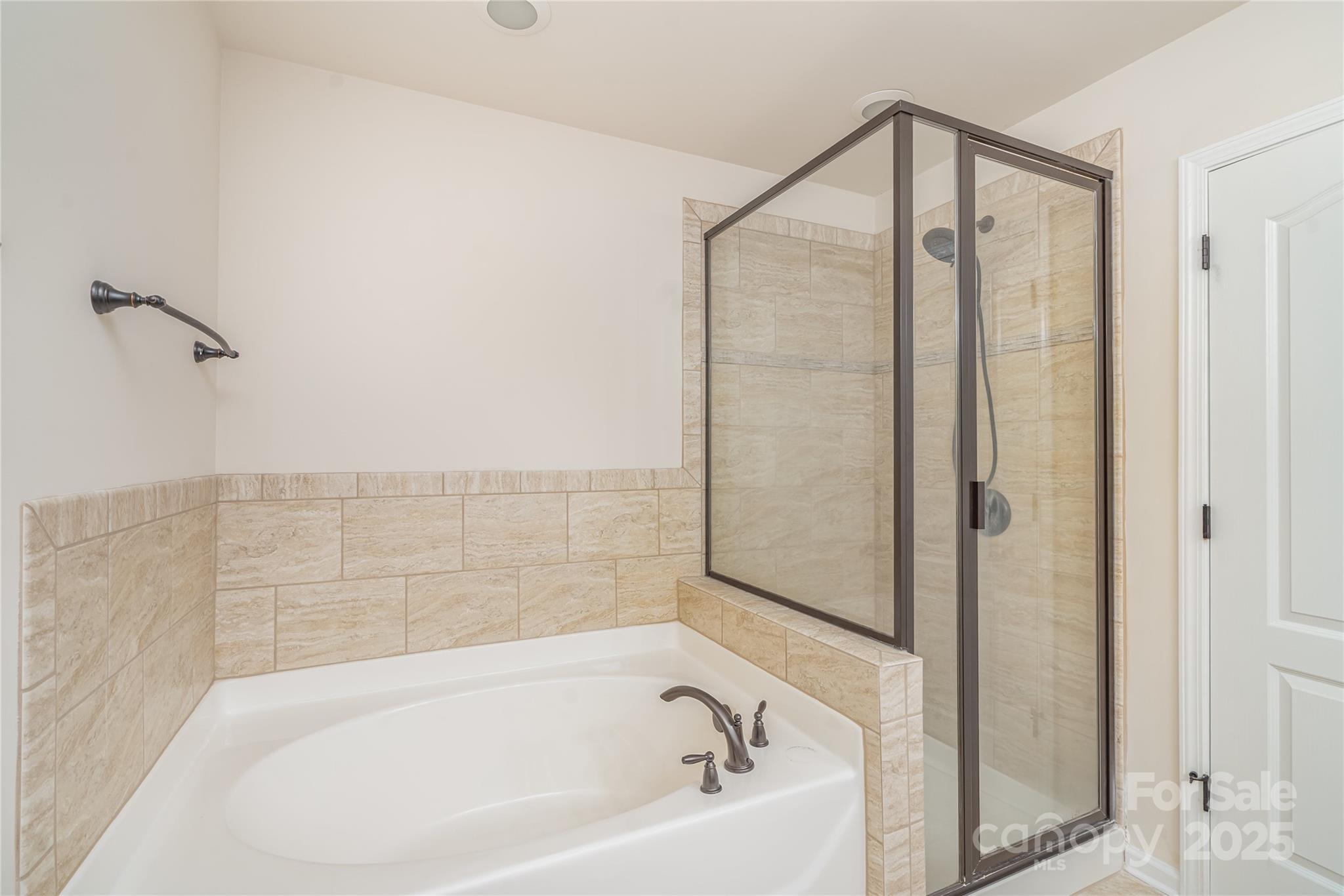 1528 Spring Blossom Trail Fort Mill, SC 29708 - Photo 15 of 26 a bathroom with a bathtub and a shower
