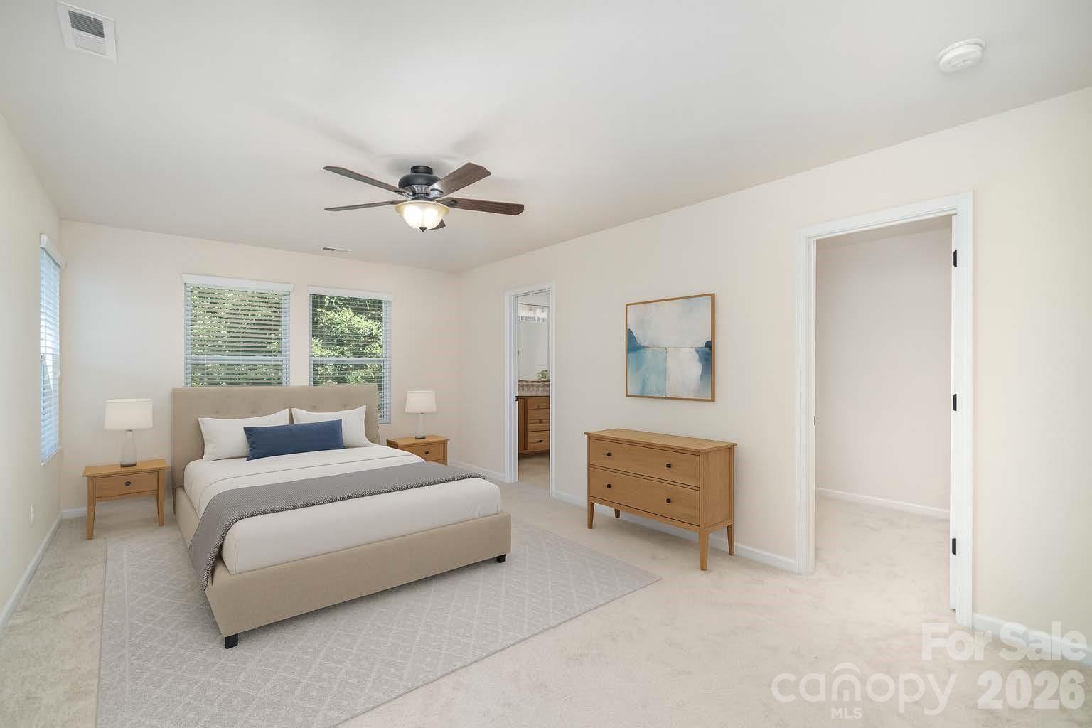 1528 Spring Blossom Trail Fort Mill, SC 29708 - Photo 15 of 31 a bedroom with a bed and a chandelier