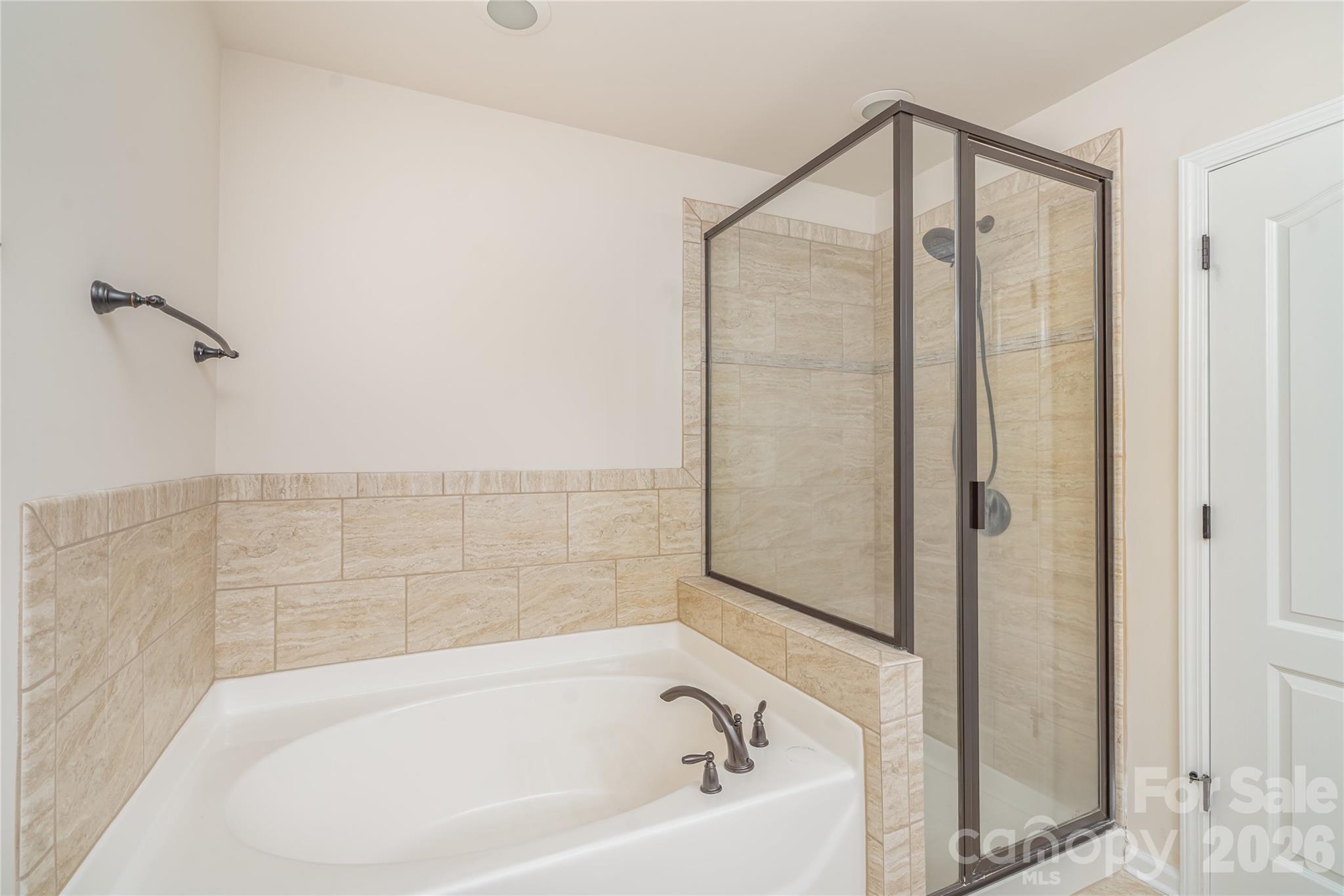 1528 Spring Blossom Trail Fort Mill, SC 29708 - Photo 17 of 31 a bathroom with a bathtub and a shower