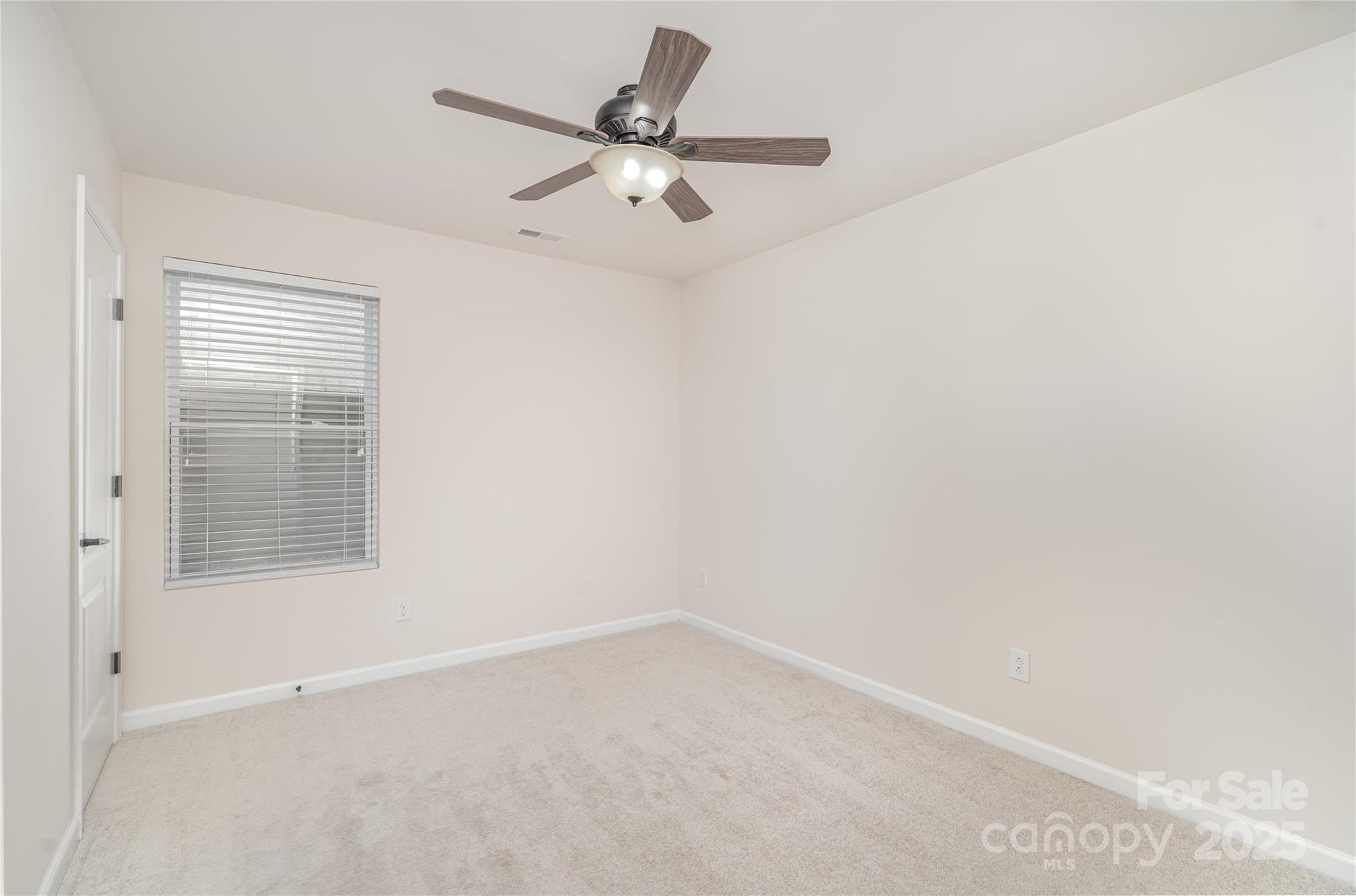 1528 Spring Blossom Trail Fort Mill, SC 29708 - Photo 19 of 26 an empty room with a window