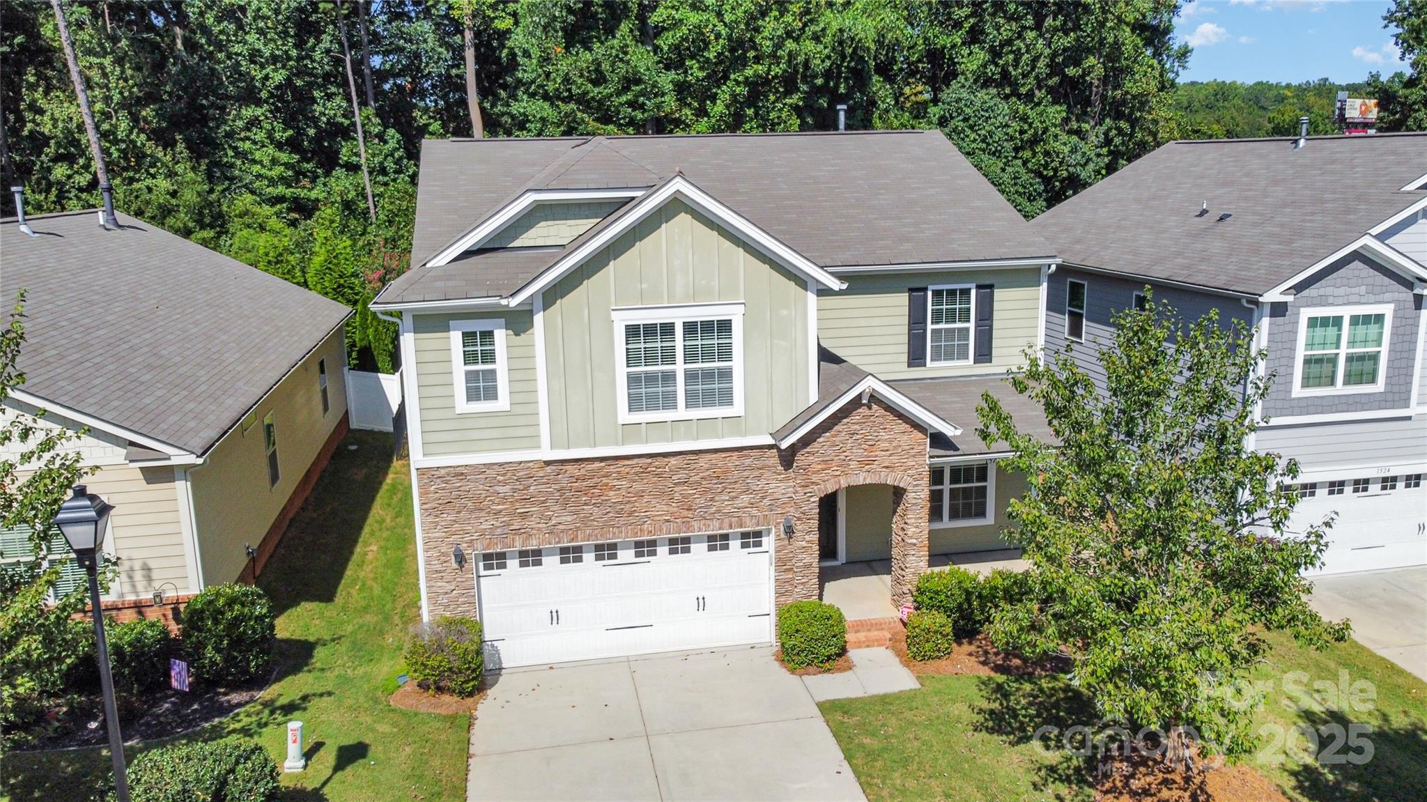 1528 Spring Blossom Trail Fort Mill, SC 29708 - Photo 2 of 26 a view of house with garden and tall tree