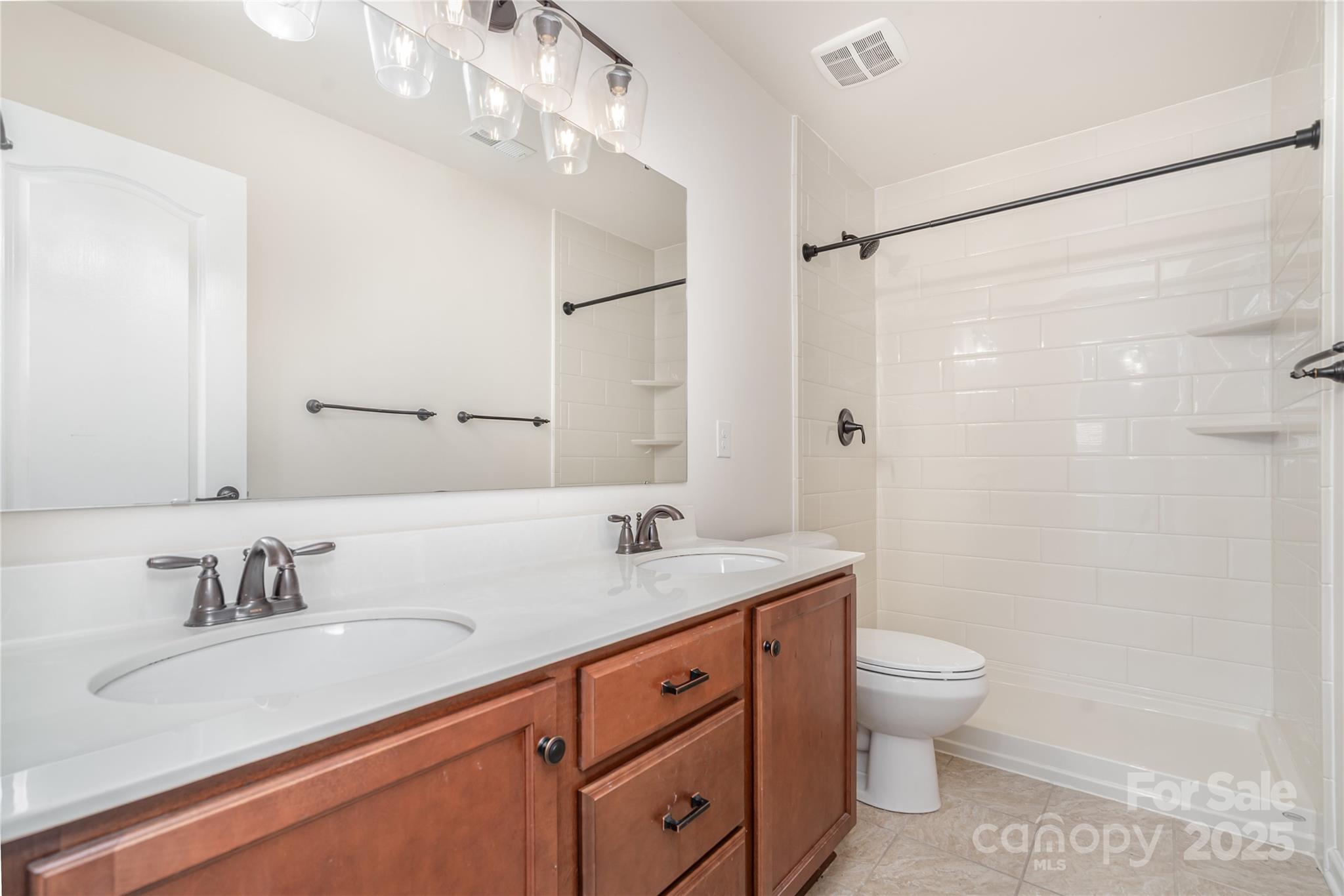 1528 Spring Blossom Trail Fort Mill, SC 29708 - Photo 21 of 26 a bathroom with a granite countertop sink a toilet and a shower