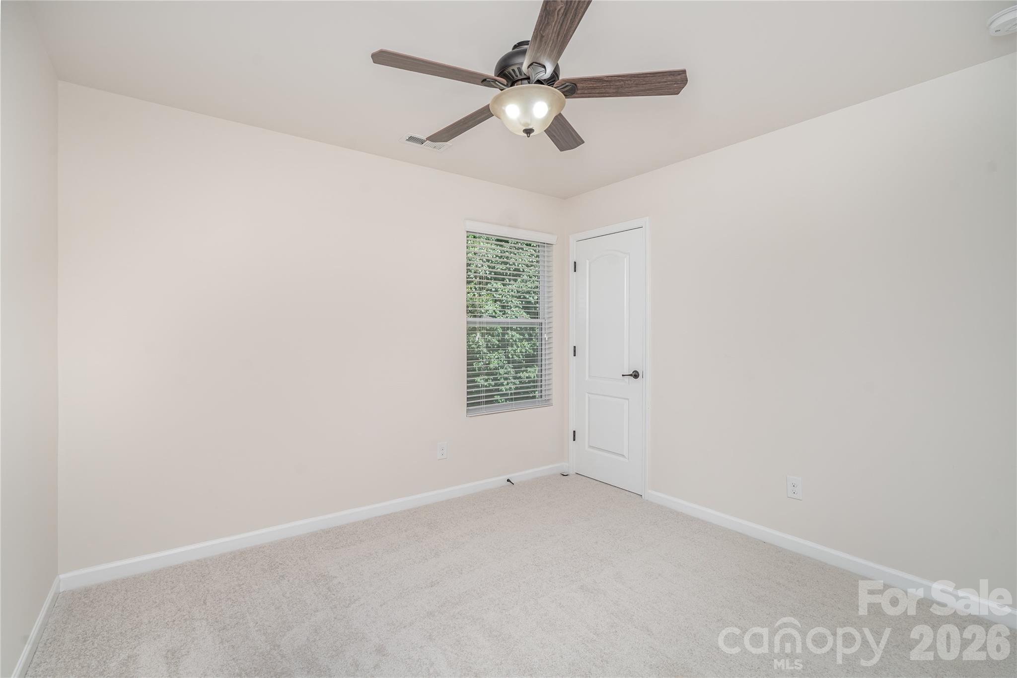 1528 Spring Blossom Trail Fort Mill, SC 29708 - Photo 24 of 31 an empty room with a window and a fan