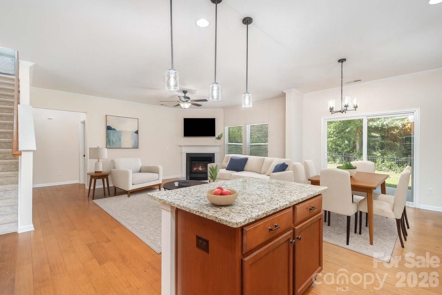 1528 Spring Blossom Trail Fort Mill, SC 29708 - Photo 10 of 31 a open kitchen with stainless steel appliances granite countertop a stove top oven a sink dishwasher and a fireplace with the view