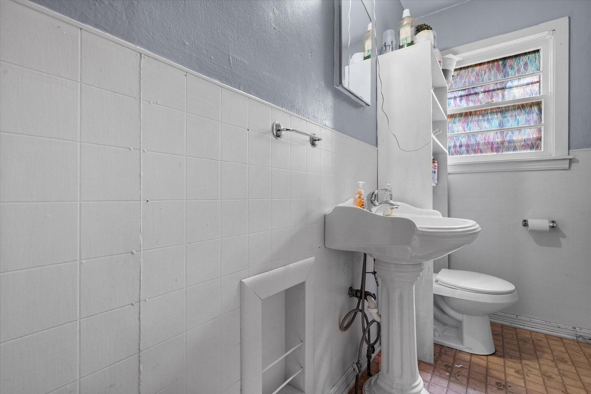 2013 58th Street Lubbock, TX 79412 - Photo 13 of 17 a bathroom with a sink toilet and a mirror