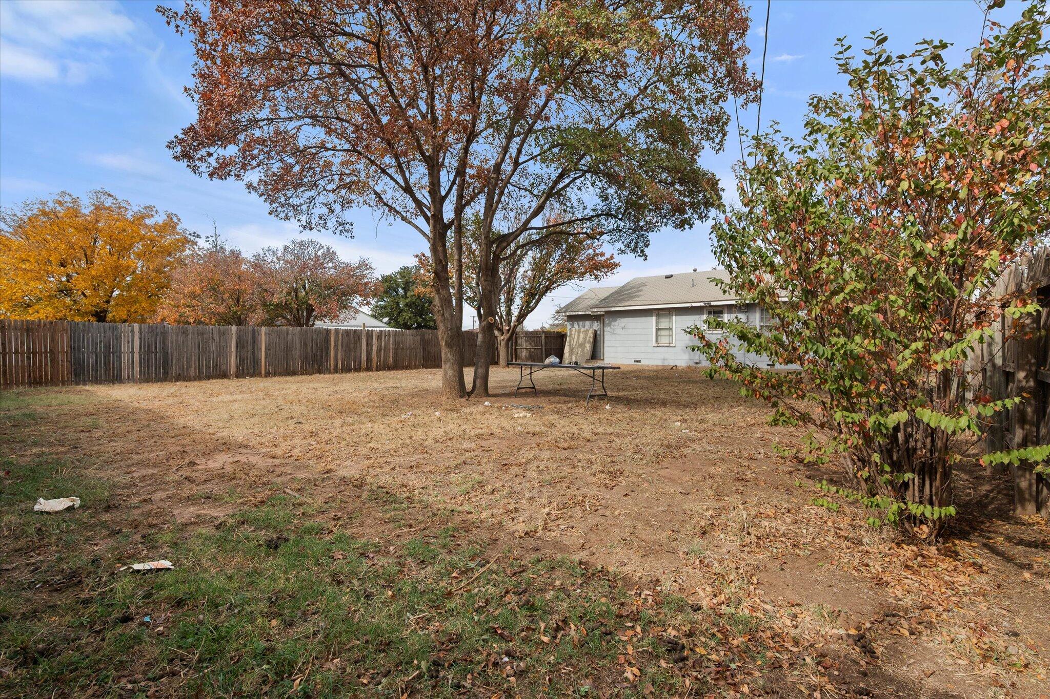2013 58th Street Lubbock, TX 79412 - Photo 16 of 17 a backyard of a house with table and chairs