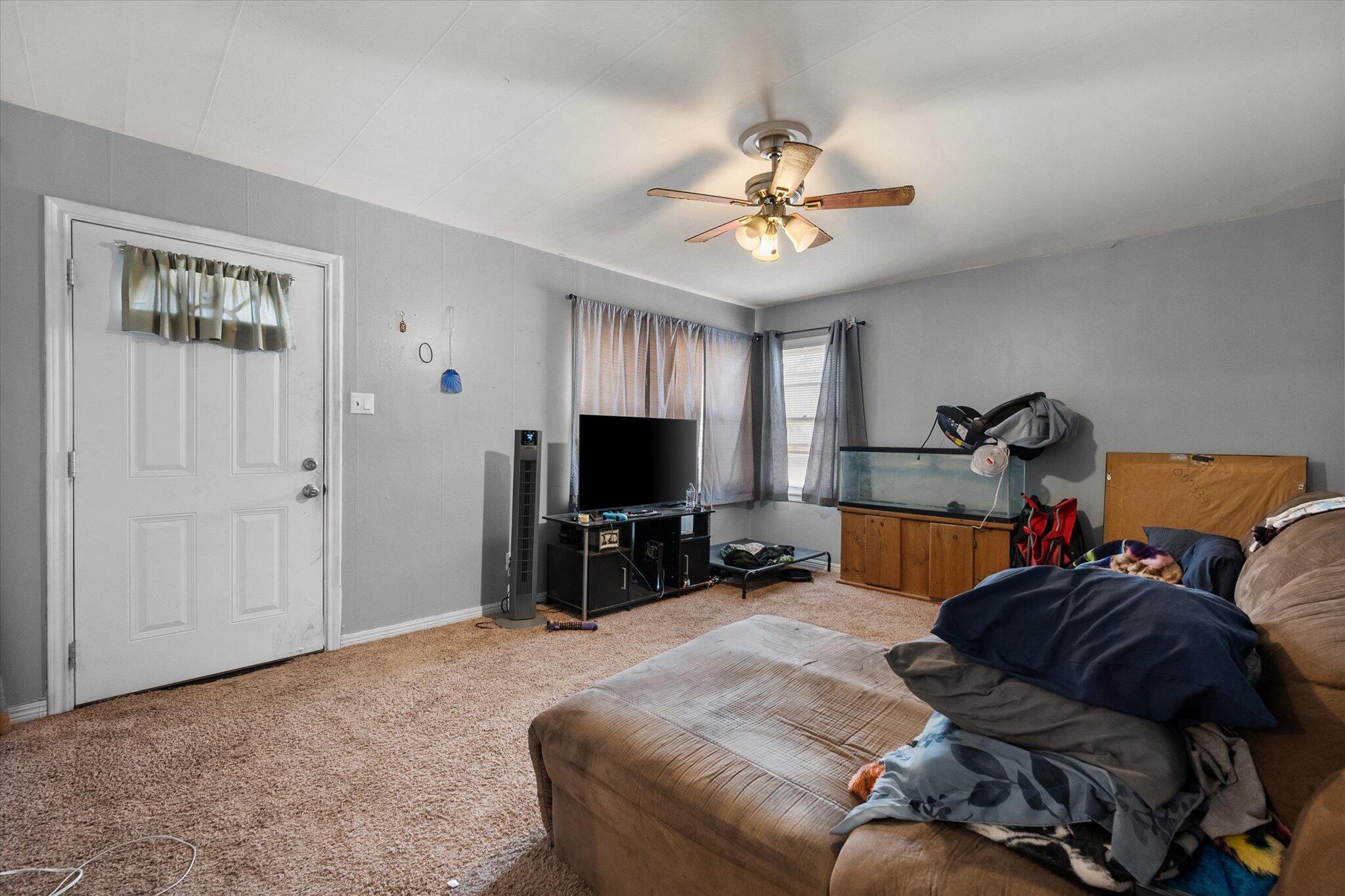 2013 58th Street Lubbock, TX 79412 - Photo 4 of 17 a living room with furniture and a flat screen tv