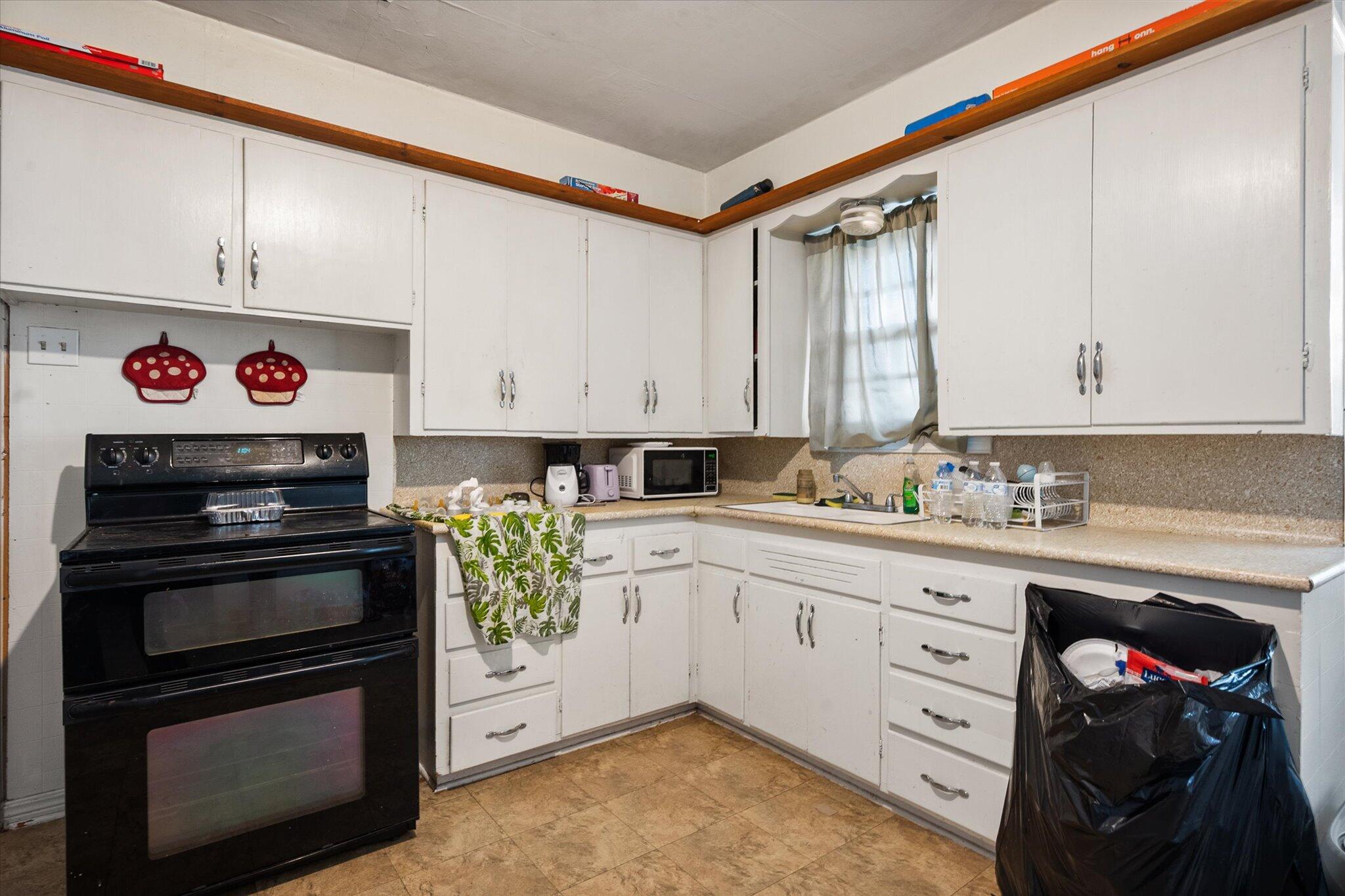 2013 58th Street Lubbock, TX 79412 - Photo 6 of 17 a kitchen with a stove and a sink