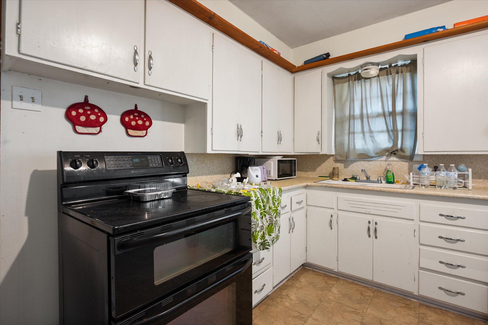 2013 58th Street Lubbock, TX 79412 - Photo 7 of 17 a kitchen with stainless steel appliances granite countertop a stove and a sink