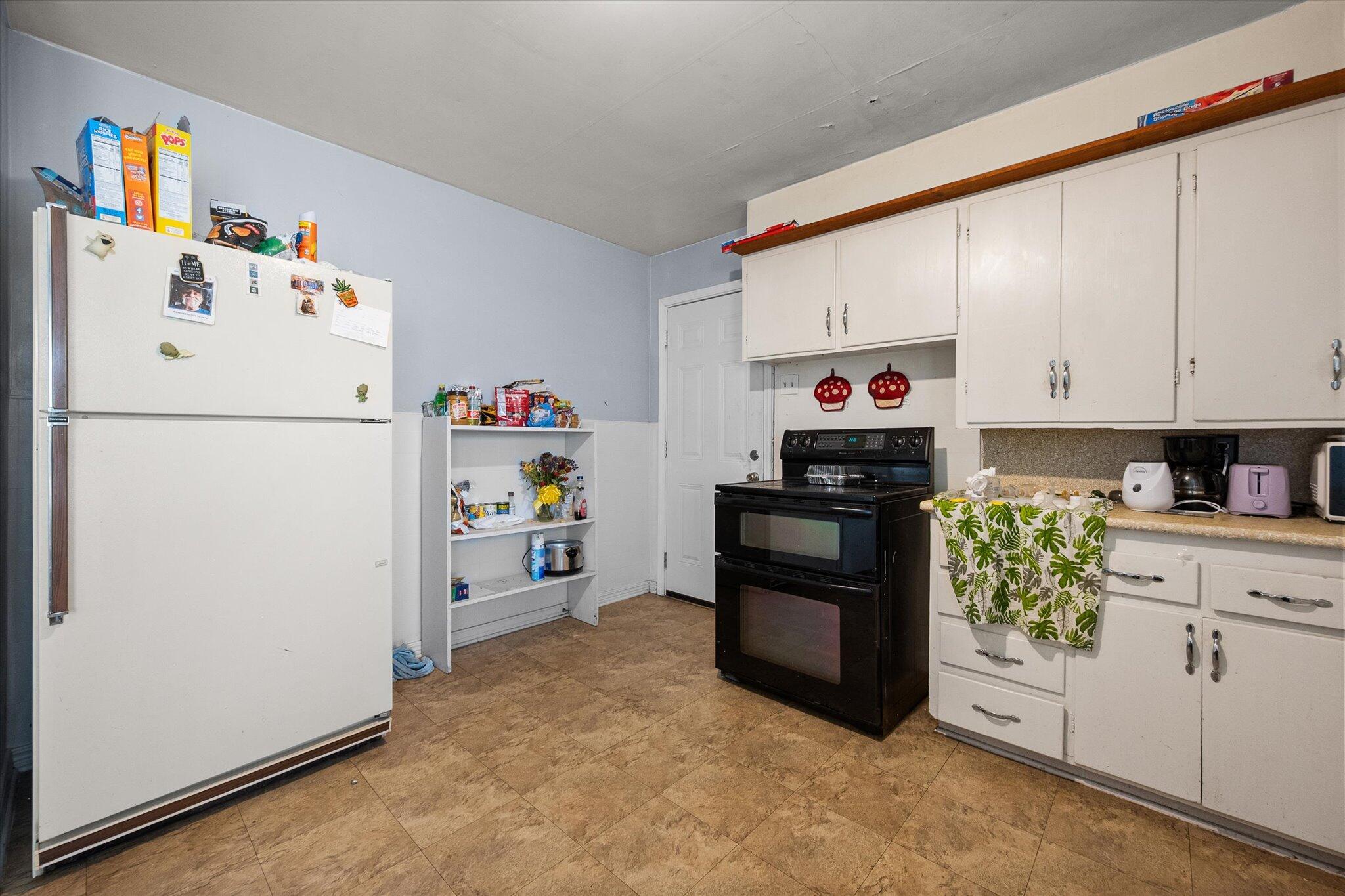 2013 58th Street Lubbock, TX 79412 - Photo 8 of 17 a kitchen with refrigerator and cabinets