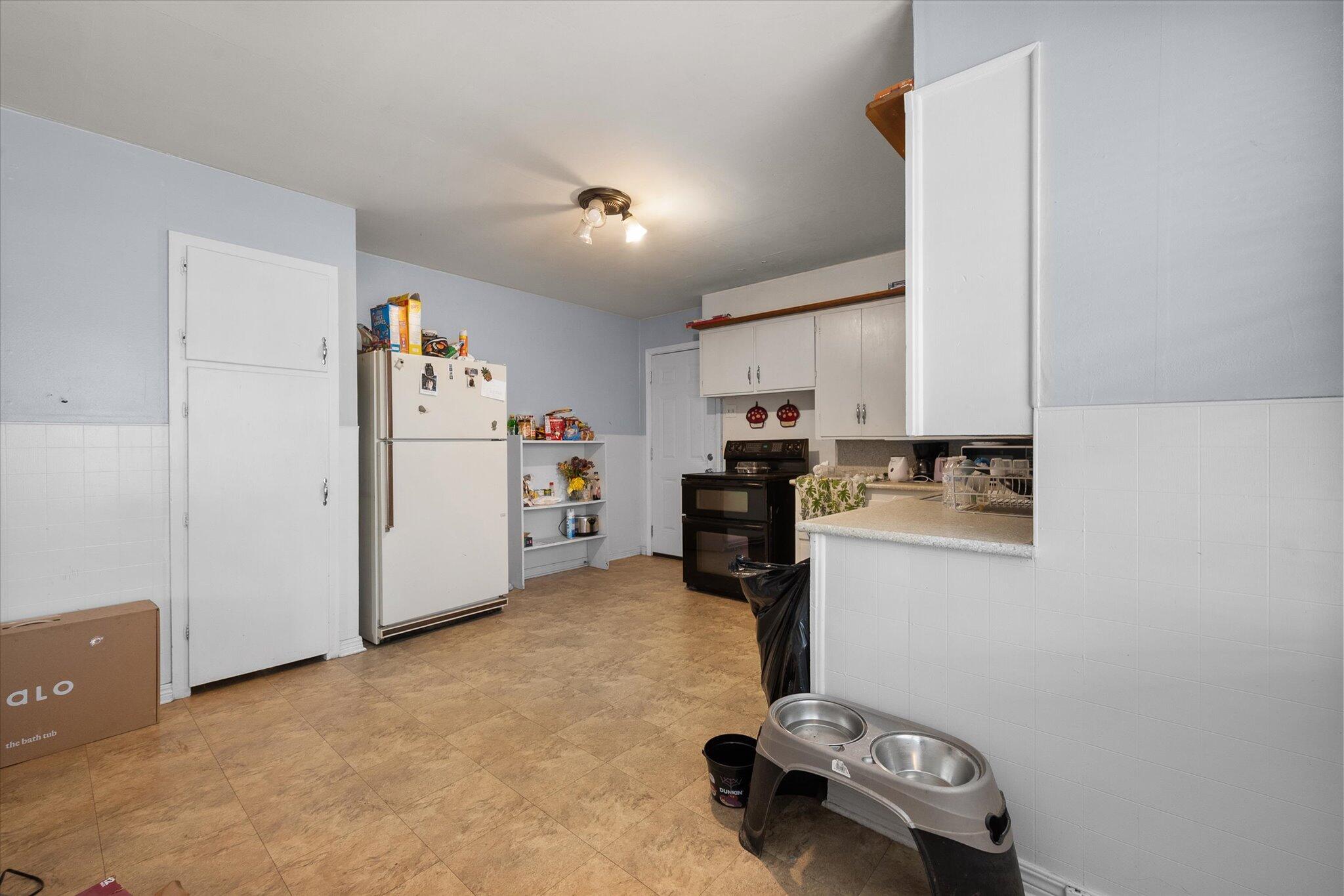 2013 58th Street Lubbock, TX 79412 - Photo 10 of 17 a room with a refrigerator and a stove top oven