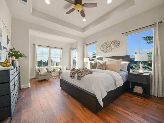 a bedroom with a bed couch and a window