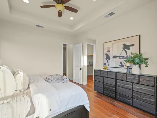 a bedroom with a bed and a chandelier