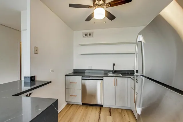 a kitchen with stainless steel appliances granite countertop a stove and a refrigerator