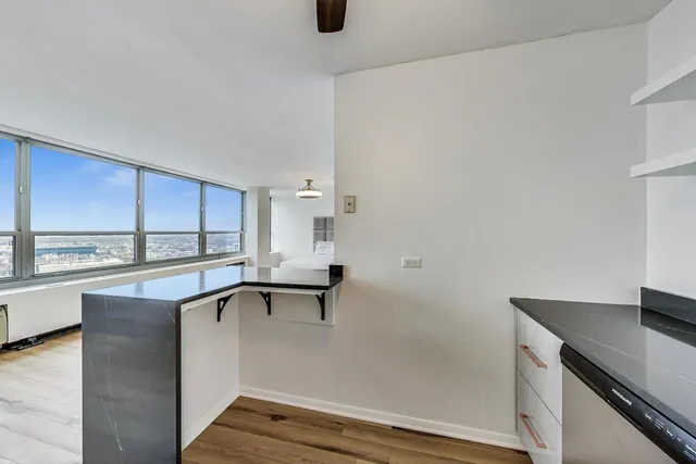 a kitchen with a sink cabinets and window