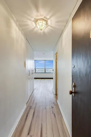 a view of a hallway with wooden floor