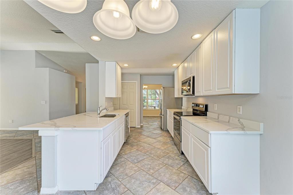 11611 Summit Rock Court Parrish, FL 34219 - Photo 23 of 54 a large white kitchen with a large window