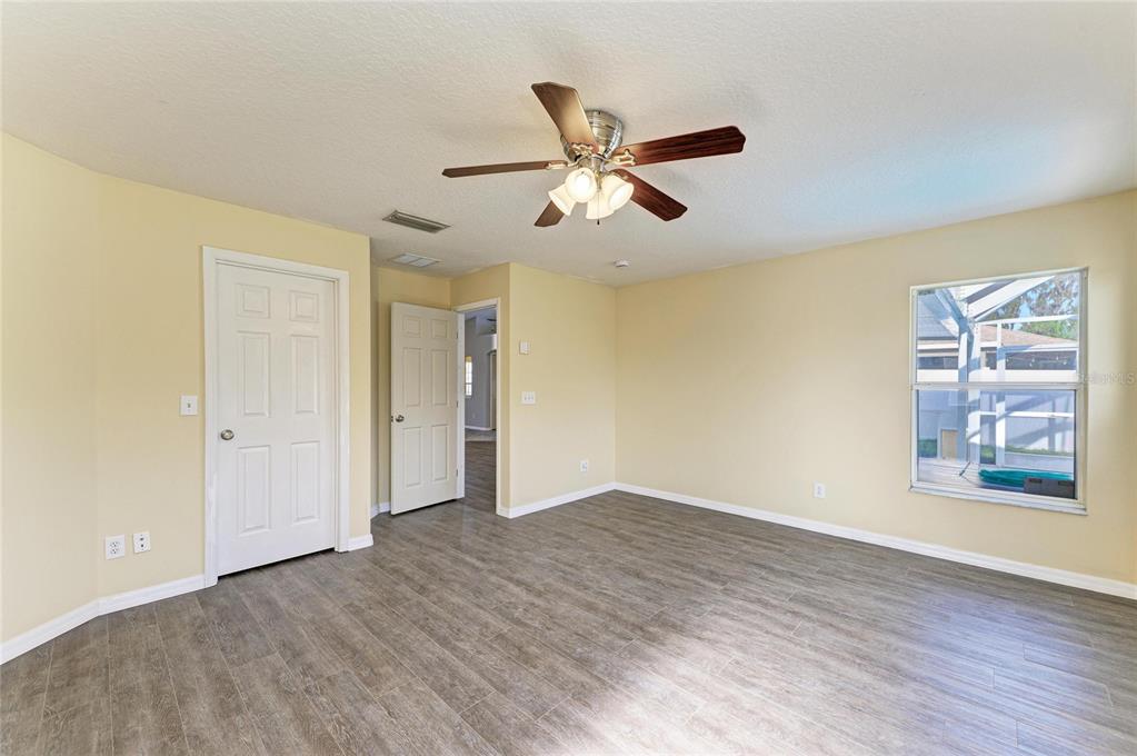 11611 Summit Rock Court Parrish, FL 34219 - Photo 29 of 54 a view of an empty room with window and wooden floor