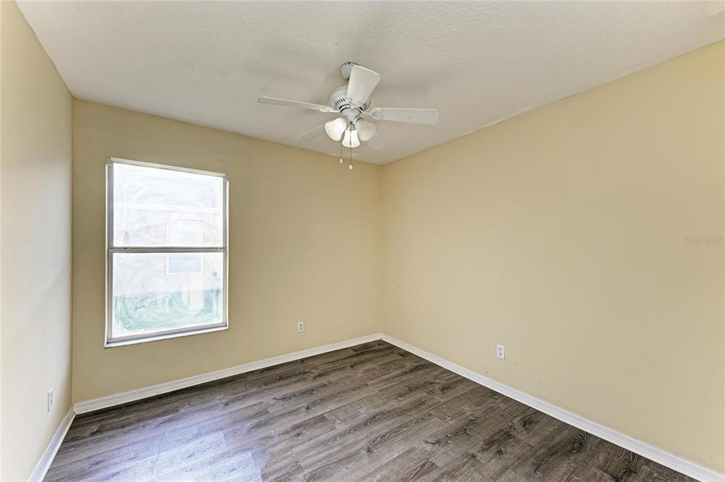 11611 Summit Rock Court Parrish, FL 34219 - Photo 36 of 54 an empty room with a window and a ceiling fan