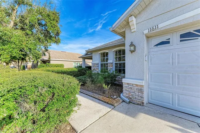 a view of a hallway with wooden floor and a chandelier