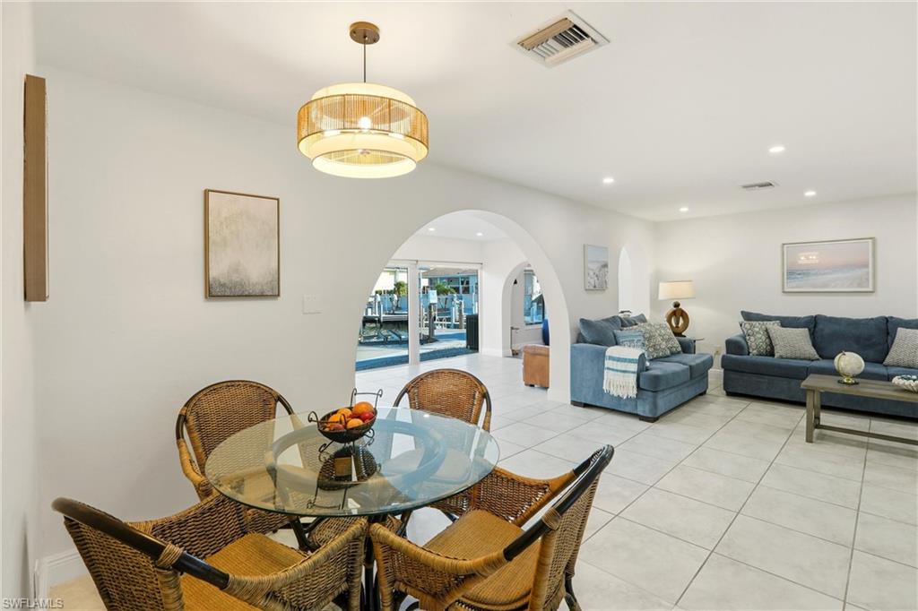 339 Landmark Street Marco Island, FL 34145 - Photo 9 of 50 Dining space featuring arched walkways, recessed lighting, and light tile patterned floors