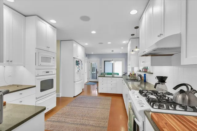 a kitchen with a sink stove and cabinets