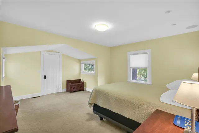 a bedroom with a bed and a dresser