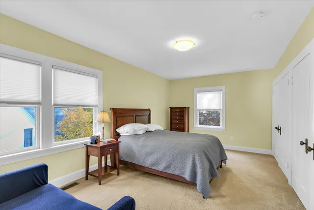 a bedroom with a bed and a painting