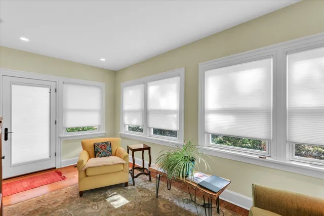 a living room with furniture rug and window