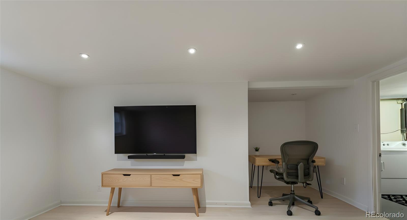 4901 Grove Street Denver, CO 80221 - Photo 13 of 25 a living room with furniture and a flat screen tv