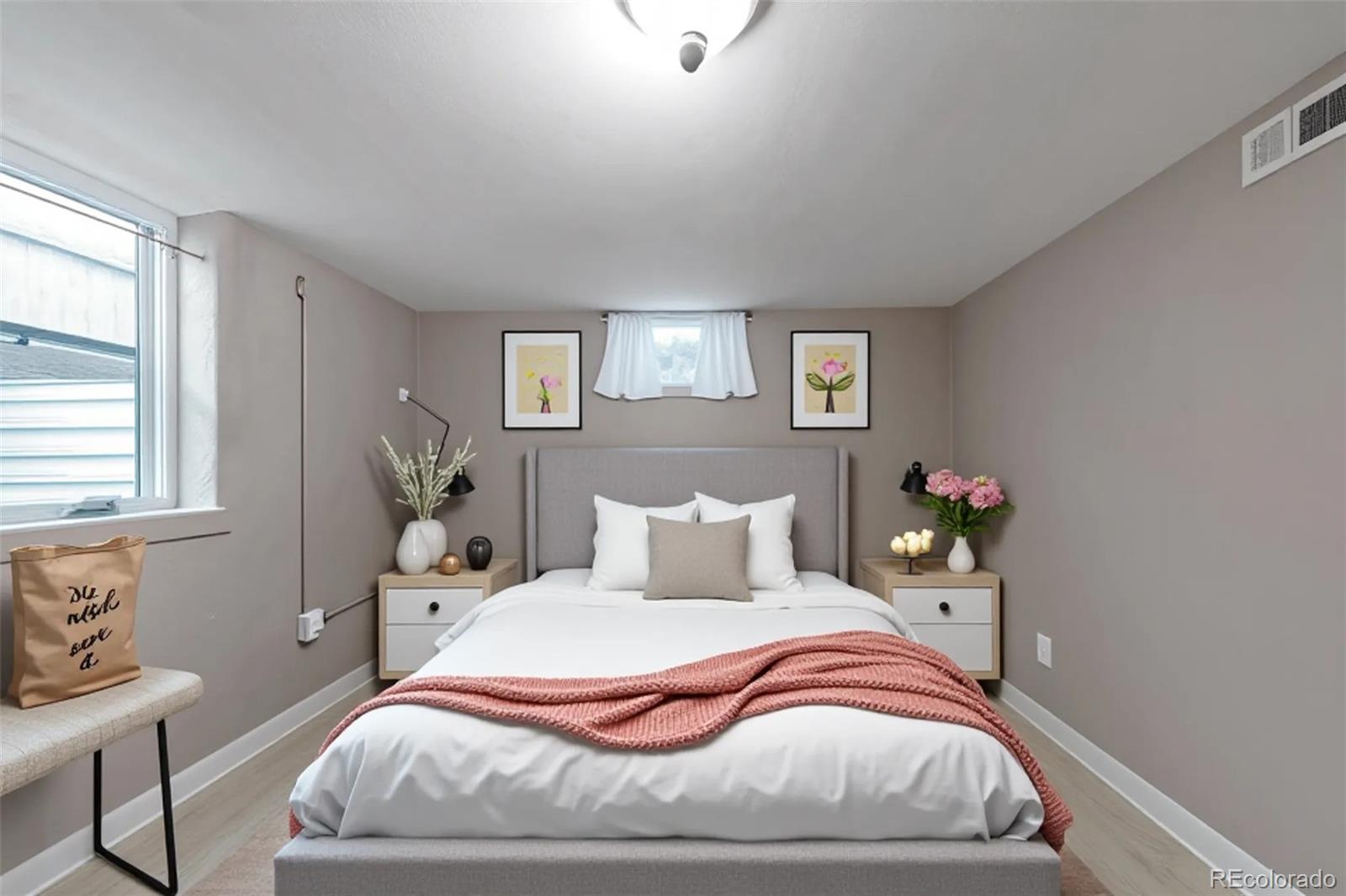 4901 Grove Street Denver, CO 80221 - Photo 15 of 25 a bedroom with a bed and chair